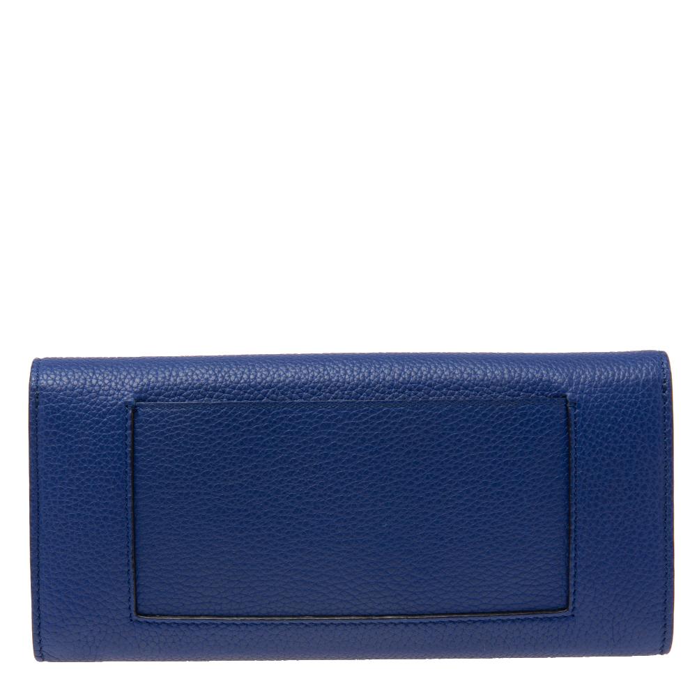 Designed to perfection, this Multifunction wallet from the House of Celine will be your go-to accessory. It is crafted using blue leather, with a gold-toned logo accent placed on the front. The flap opens to a neat leather-lined interior. This
