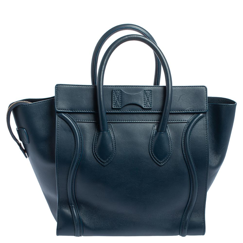 The mini Luggage tote from Celine is one of the most popular handbags in the world. This tote is crafted from leather and designed in a blue shade. It comes with rolled top handles and a front zip pocket. The bag is equipped with a well-sized