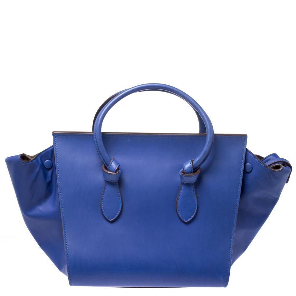 This Celine mini Tie tote is absolutely a must have. Crafted in a blue hue, it is cute, sophisticated and perfect for day or night. This Celine is far from your plain everyday bag and features knot details on the rolled handles. The suede-lined