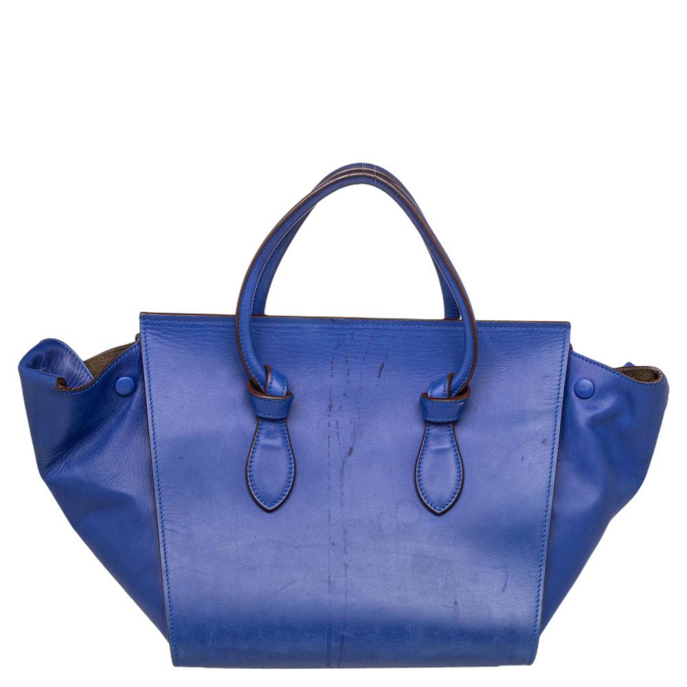 This Celine mini Tie tote is absolutely a must-have! Crafted in a blue hue, it is adorable, sophisticated, and perfect for day or night. This Celine is great to add to your everyday bag collection and features knot details on the rolled handles. The