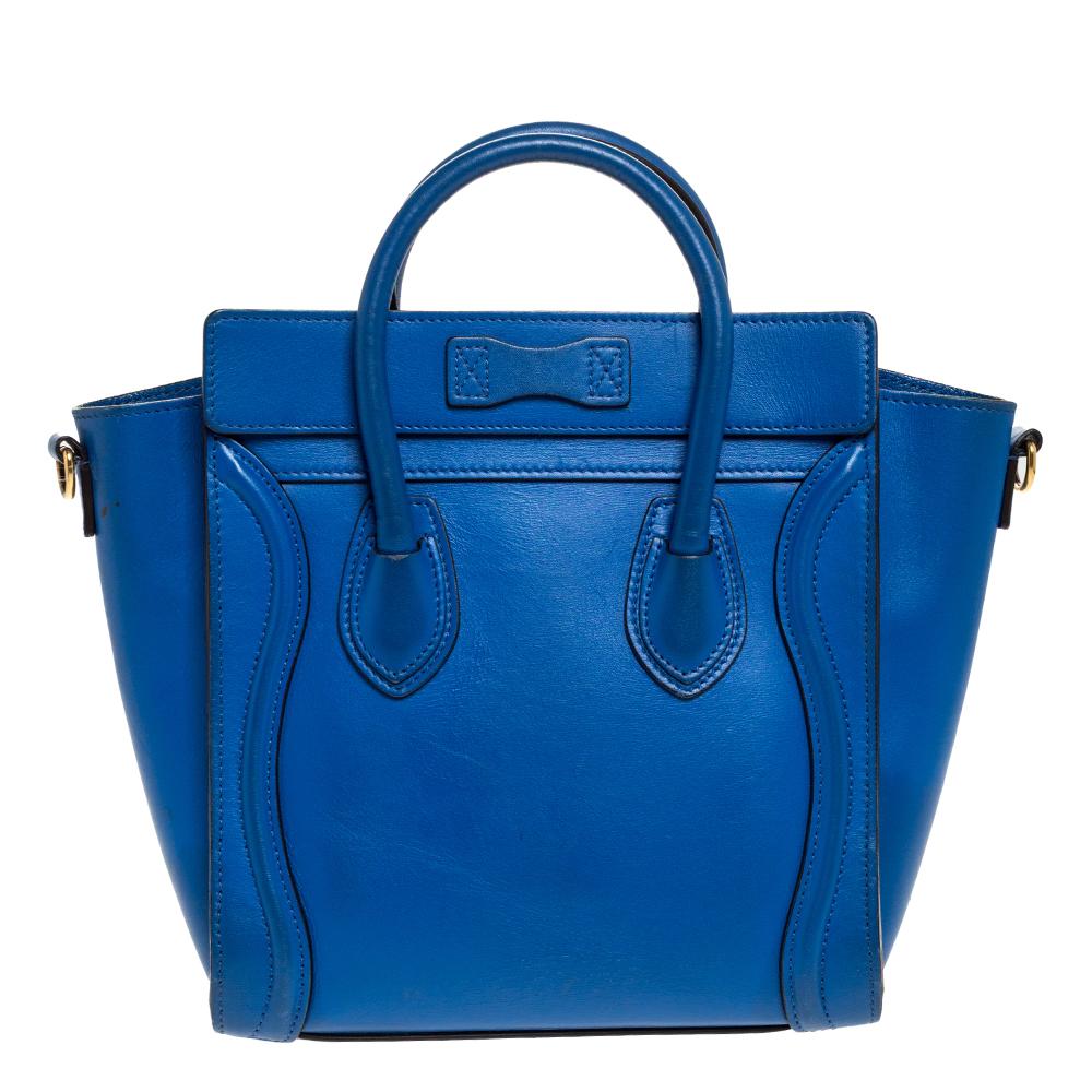 The nano Luggage tote from Celine is one of the most popular handbags in the world. This tote is crafted from leather and designed in a blue shade. It comes with rolled top handles and a front zip pocket. The bag is equipped with a well-sized