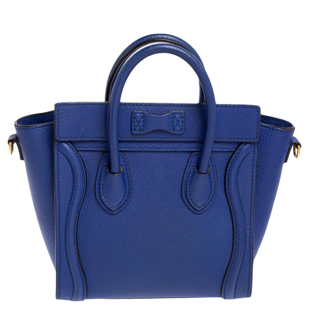 The Nano Luggage tote from Celine is one of the most popular handbags in the world. This tote is crafted from leather and designed in a blue shade. It comes with rolled top handles, a detachable shoulder strap, and a front zip pocket. The bag is