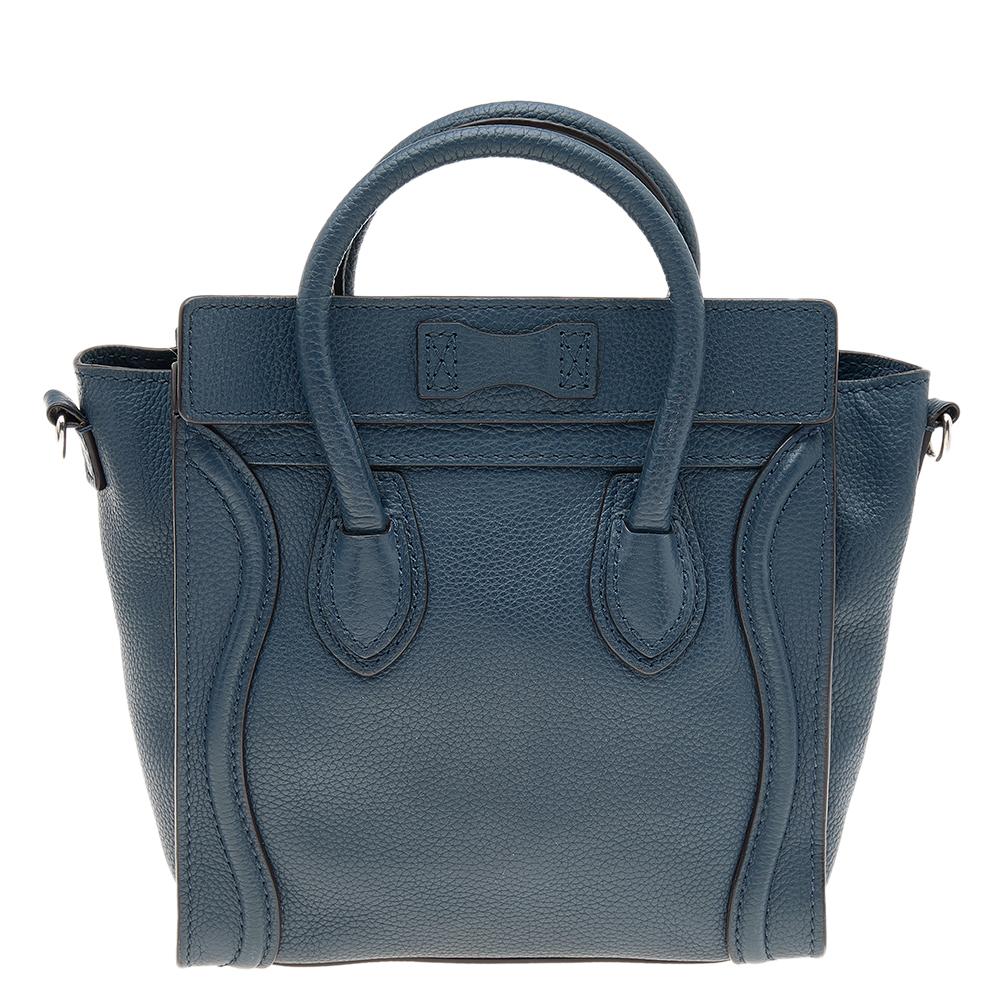 The Nano Luggage tote from Celine is one of the most popular handbags in the world. This tote is crafted from leather and designed in a blue shade. It comes with rolled top handles, a detachable shoulder strap, and a front zip pocket. The bag is