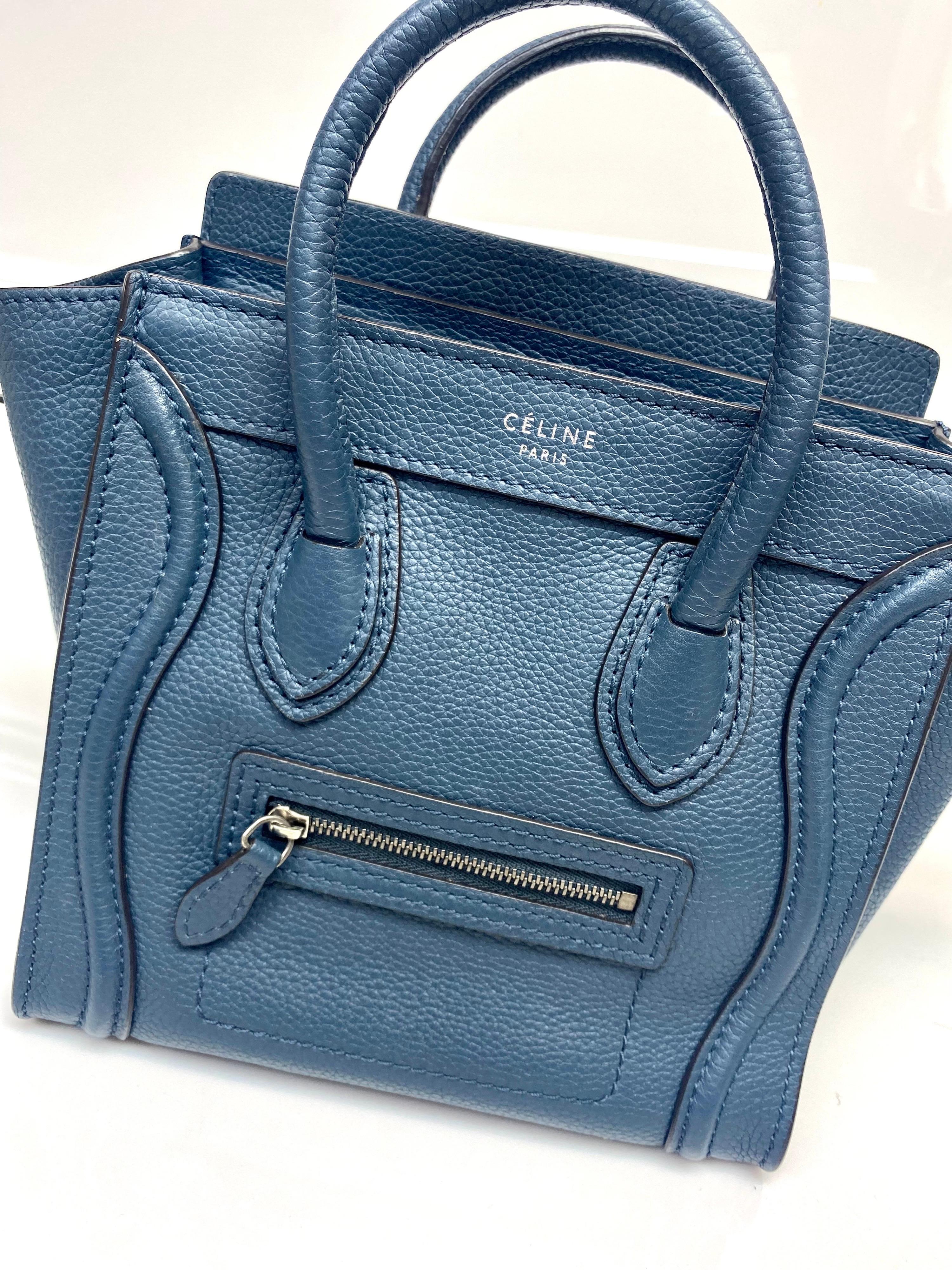 The Nano Luggage tote from Celine is one of the most popular handbags in the world because of its style and practicality. This tote is crafted from leather and designed in a blue shade. It comes with rolled top handles and a front zip pocket. The