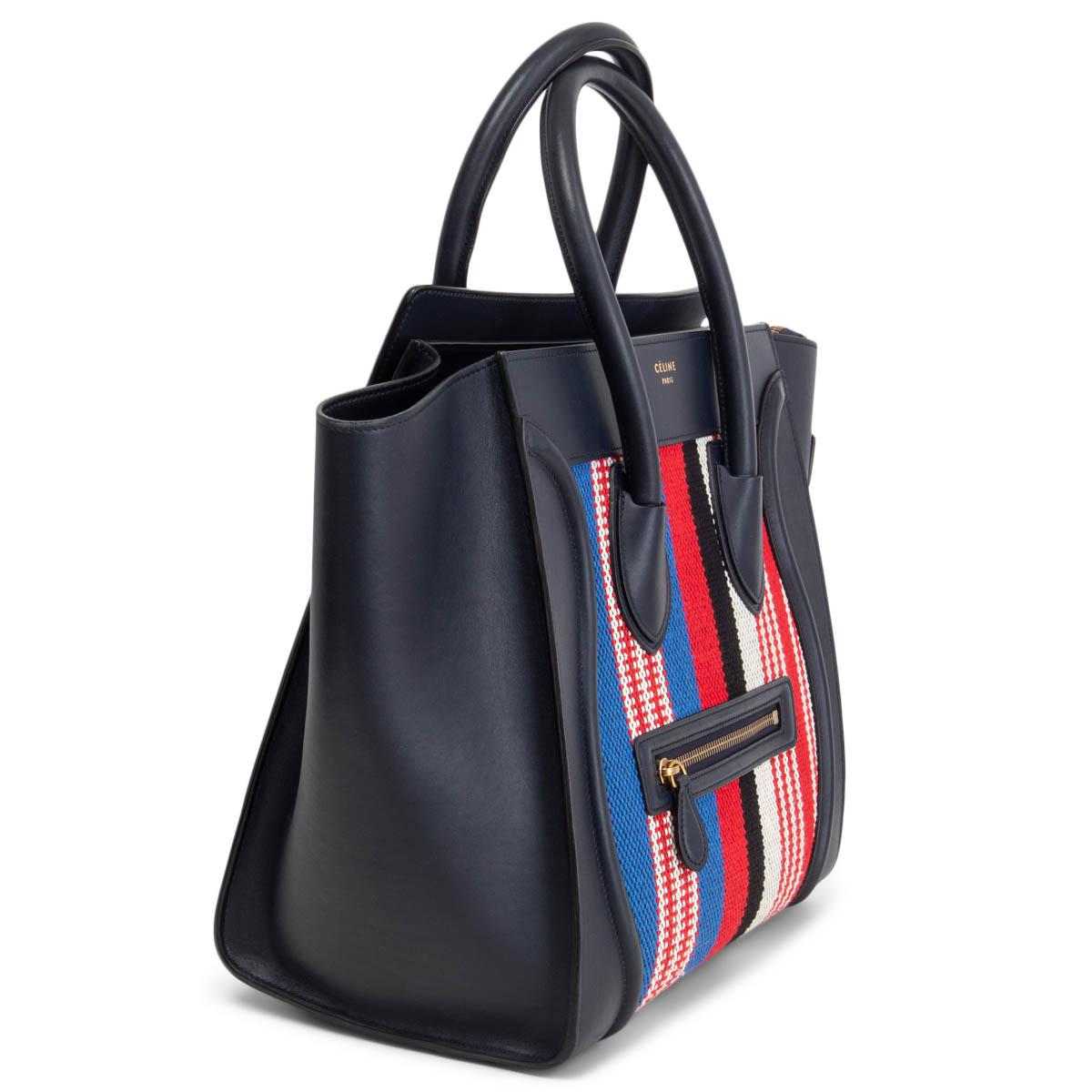 100% authentic Céline Mini Luggage in midnight blue calfskin and red, white, black and blue canvas front and back. Resort 2016 collection. Zipper pocket on the front. Opens with a zipper on top and is lined in midnight blue leather with two open