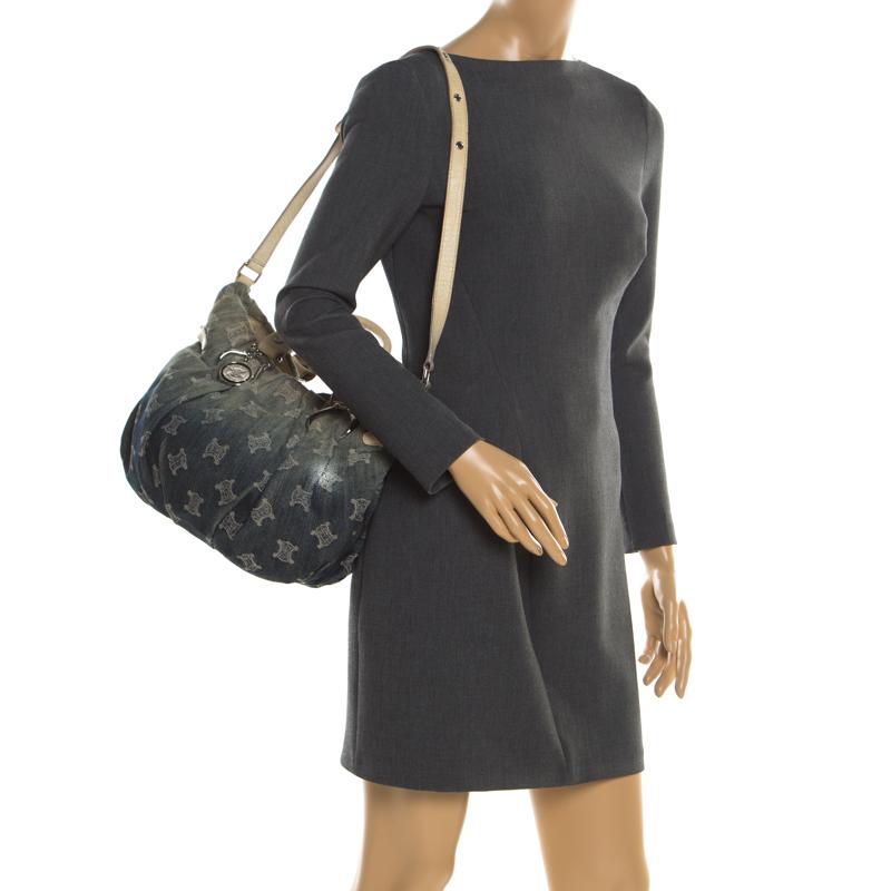 This tote from Celine has been crafted from Macadem denim and croc-embossed leather. The bag comes held by two handles, a shoulder strap and it has a spacious fabric interior that is well-sized to carry your belongings.

