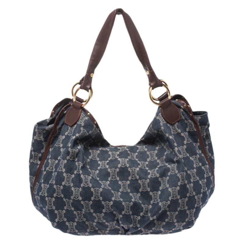 This spacious Celine hobo is stylish and practical. It is crafted from blue Macadam-coated denim and leather and is equipped with handles and a drop charm at the front. The spacious bag opens up to a denim-lined interior that has pockets.

