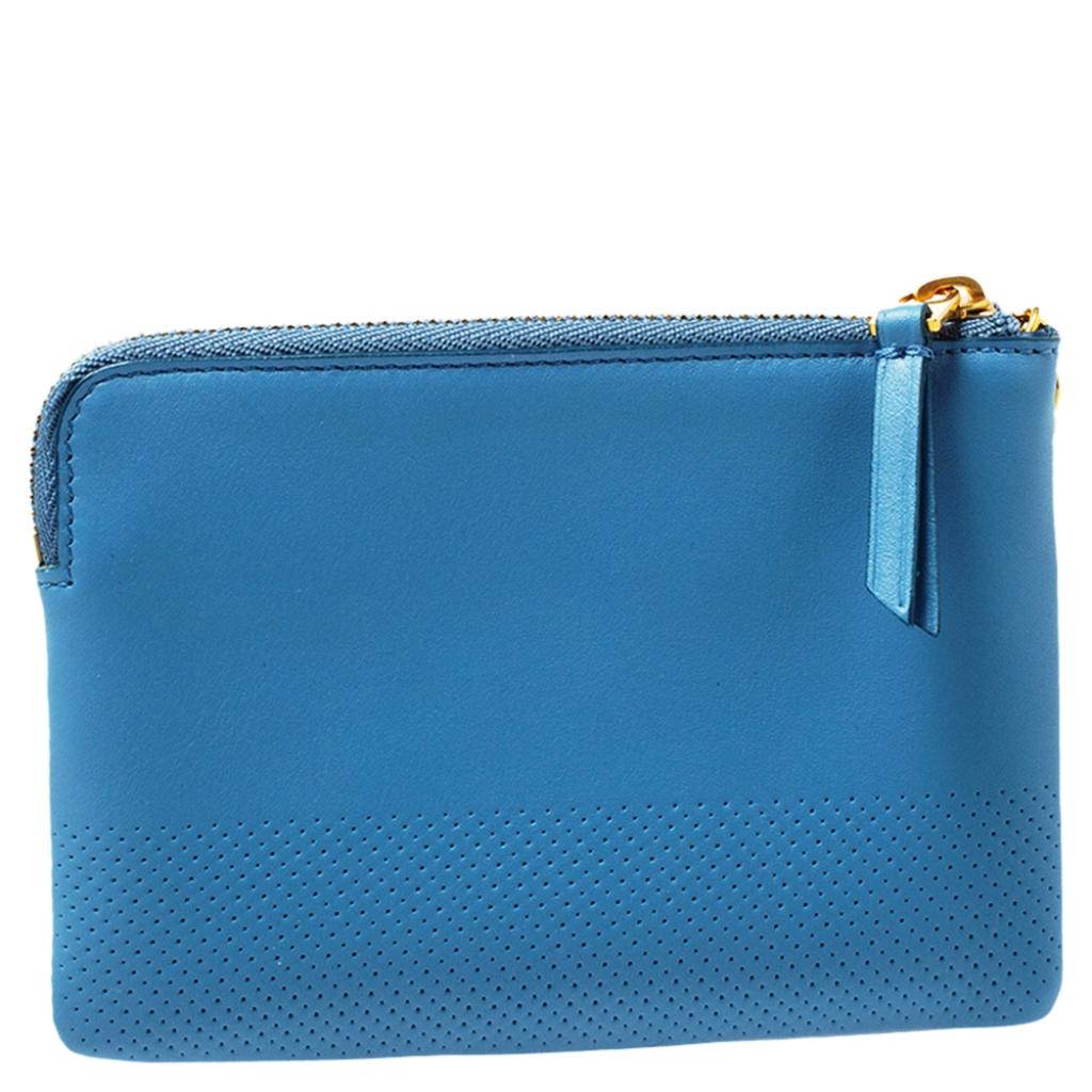 This Celine purse is conveniently designed for everyday use. Crafted from perforated blue leather, the wallet has a zip closure that opens to reveal multiple slots for you to neatly arrange your coins and cards.

Includes:Original Dustbag, Original