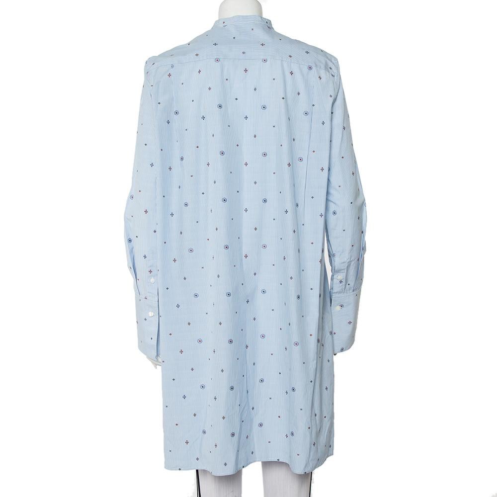 Tailored beautifully using cotton, this oversized shirt dress from Celine will be a fashionable addition to your summer wardrobe. It has long sleeves, button closure, an asymmetric high-low hemline, and embroidered details all over its striped