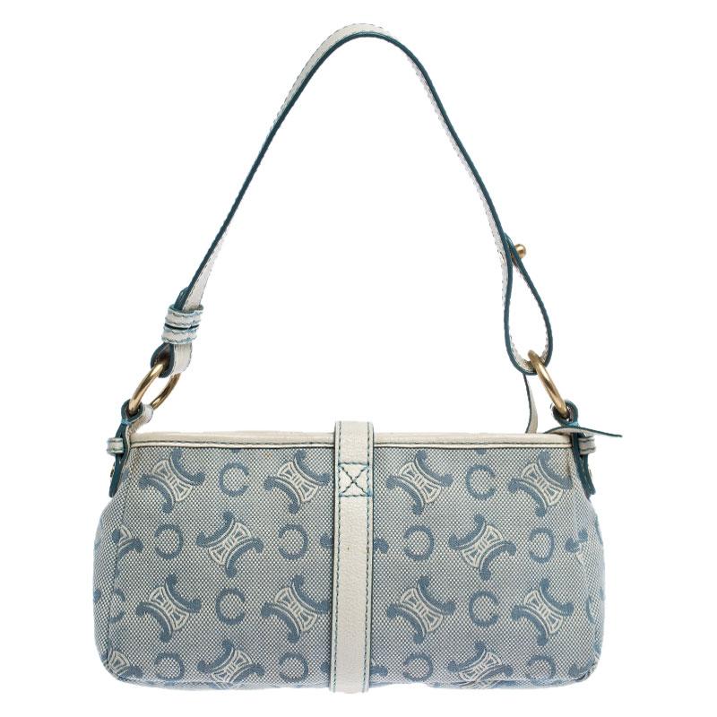 This stunning shoulder bag by Celine has been crafted from the brand's signature monogram canvas and leather. It comes in lovely hues of white and blue and features a buckled strap and zip closure. The interior is lined with canvas and has enough