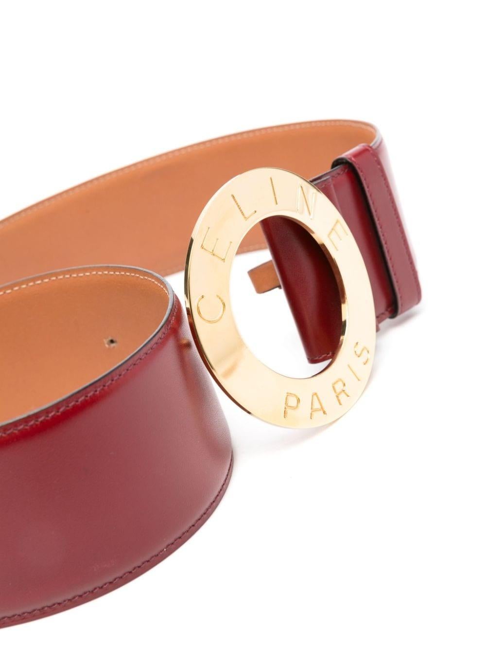 Celine large bordeaux leather belt featuring a large round logo-engraved buckle, adjustable fit, a pin-buckle fastening, an inside pitted logo, delivered in original Celine vintage box.
Estimated Size: S 
Circa:1990s
Length Maxi: 32in.