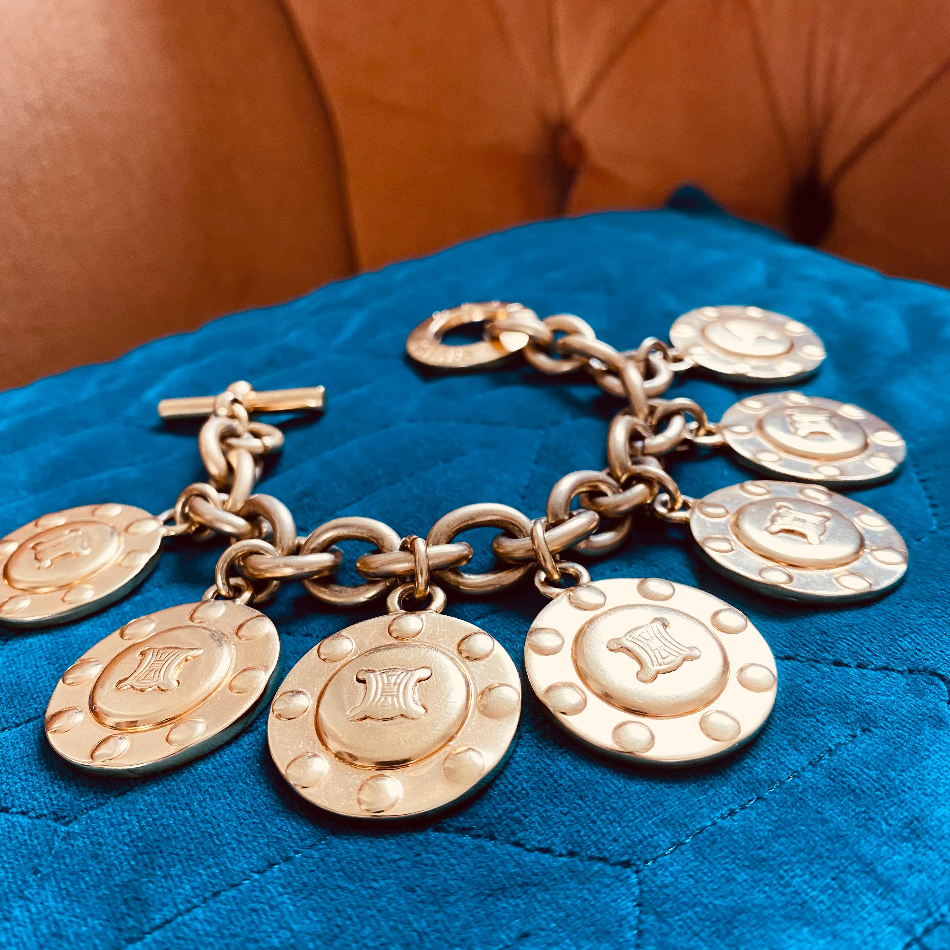 Celine Vintage 1980s Charm Bracelet
Incredible statement charm bracelet from the iconic house of Celine

Detail
-Made in Italy in the 1980s
-Crafted from high quality gold plated metal
-Large circular charms on a chunky chain bracelet with a toggle