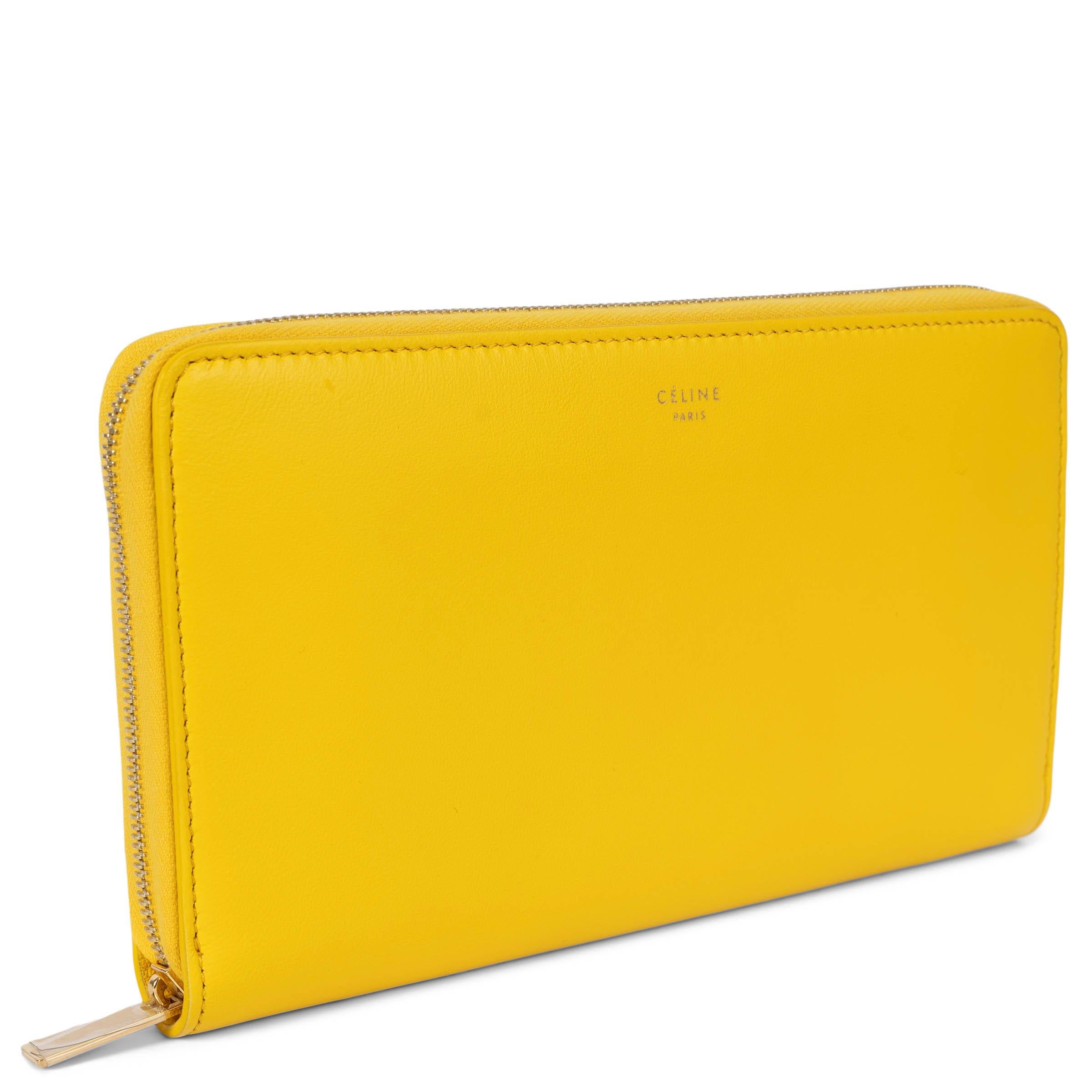 100% authentic Céline Continental zipper wallet in smooth yellow calfskin featuring gold-tone hardware. Lined in yellow leather with twelve credit card slots, one zipper pocket and two bill compartments on the side. Brand new. Comes with dust bag.