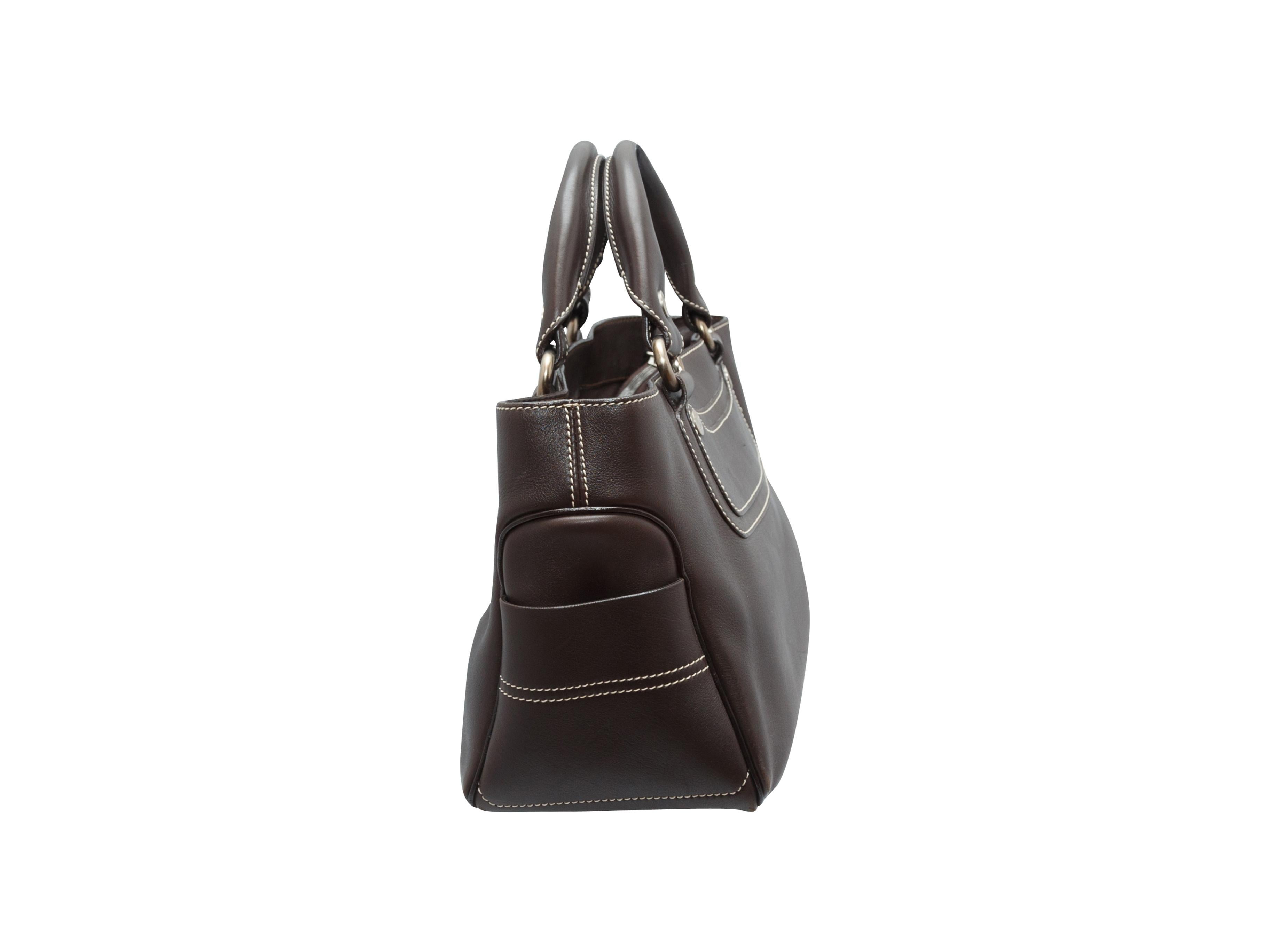 Product details: Dark brown Boogie leather bag by Celine. Interior zip pocket. Contrast stitching throughout. 13.5