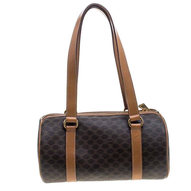 Celine Boston bags are a craze among the fashion enthusiasts. Ideal for stylish travellers, this bag is crafted with macadam coated canvas in deep brown hue. Featuring twin handles, top zip closure and a spacious leather-lined interior, this bag is