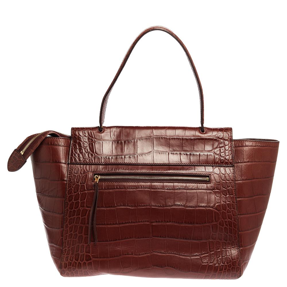 Designed in a gorgeous shape, this Belt Bag by Celine is a great style enhancer. Crafted from croc-embossed leather, it has a tuck-in flap that opens to a spacious suede-lined interior. The brown bag is further equipped with a zip pocket at the back