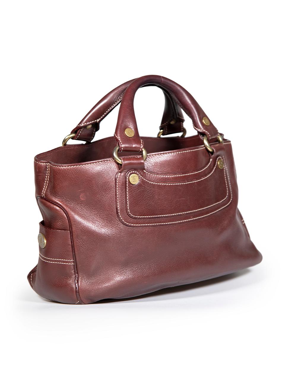 CONDITION is Good. General wear to bag is evident. Moderate signs of wear to the front, back, sides and handles with abrasions to the leather. The left side pocket trim has come away leaving the leather facings open on this used Céline designer