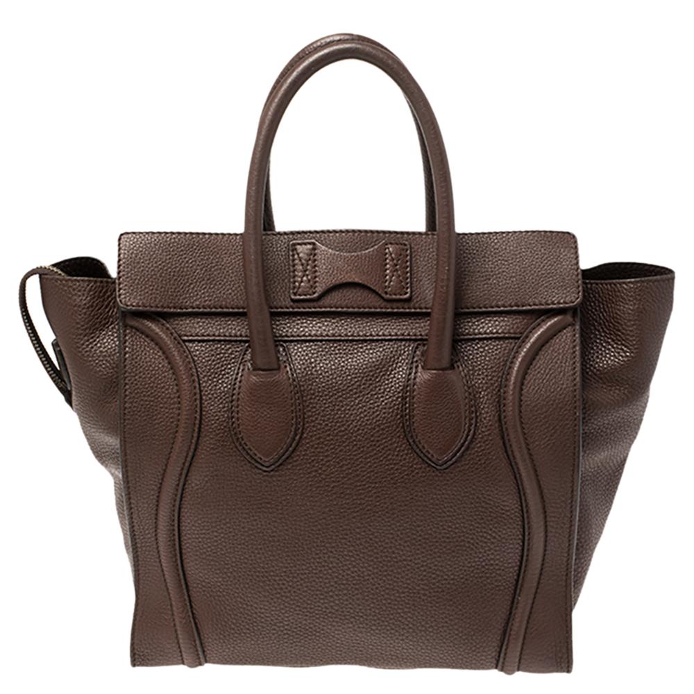The mini Luggage tote from Celine is one of the most popular handbags in the world. This tote is crafted from leather and designed in a brown shade. It comes with rolled top handles and a front zip pocket. The bag is equipped with a well-sized
