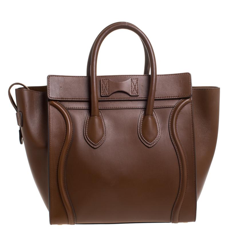 The mini Luggage tote from Celine is one of the most popular handbags in the world. This tote is crafted from leather and designed in a brown shade. It comes with rolled top handles, protective metal feet and a front zip pocket. The bag is equipped