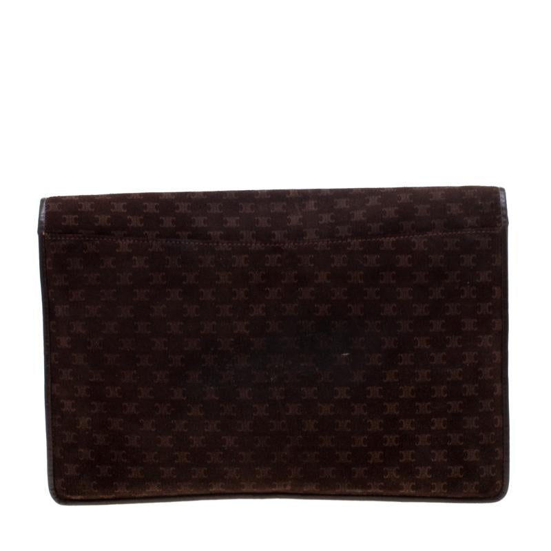 This Celine clutch epitomizes fun, grace and style. A perfect blend of charm and elegance, this suede clutch is trimmed with leather and is adorned with the signature print all over. Available in a brown colour, this fashionable creation is all you