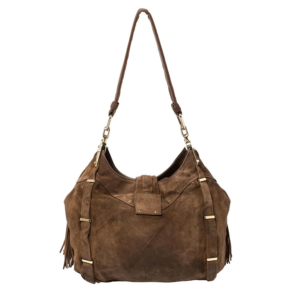 This Dimitri bag is luxurious, with soft brown suede and a jewel accent on the metal tab close. The leather shoulder strap is provided to sling the bag over your shoulder comfortably and there are inner pockets in the bright satin lined interior.