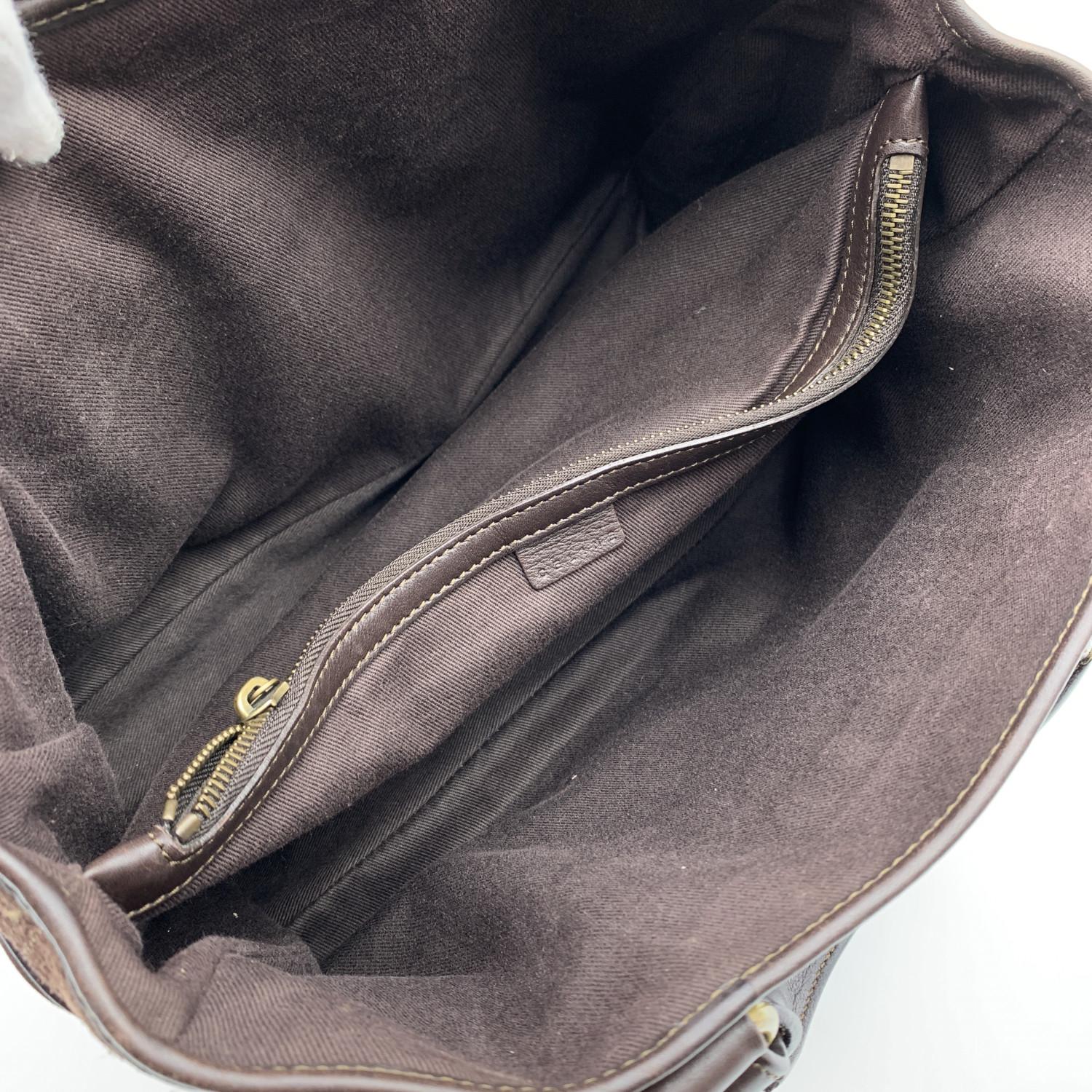Celine 'Boogie' Bag . Brown suede with engraved C and Macadam pattern. Brown genuine leather trim. Gold metal hardware . One patch pocket on each side of the bag. Brown canvas lining. 3 compartments and 1 of them is zipped, 'CELINE' tag inside (with