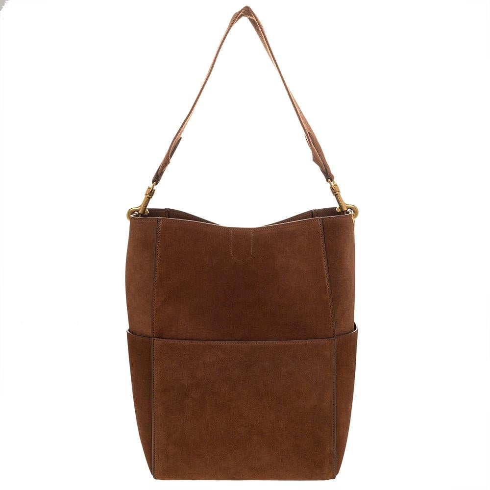 This super cool and stylish handbag by Celine will surely fetch you a lot of compliments. Get your hands on this striking suede bag to integral your work-week look. The interior is lined with leather and has enough space for all your essentials.