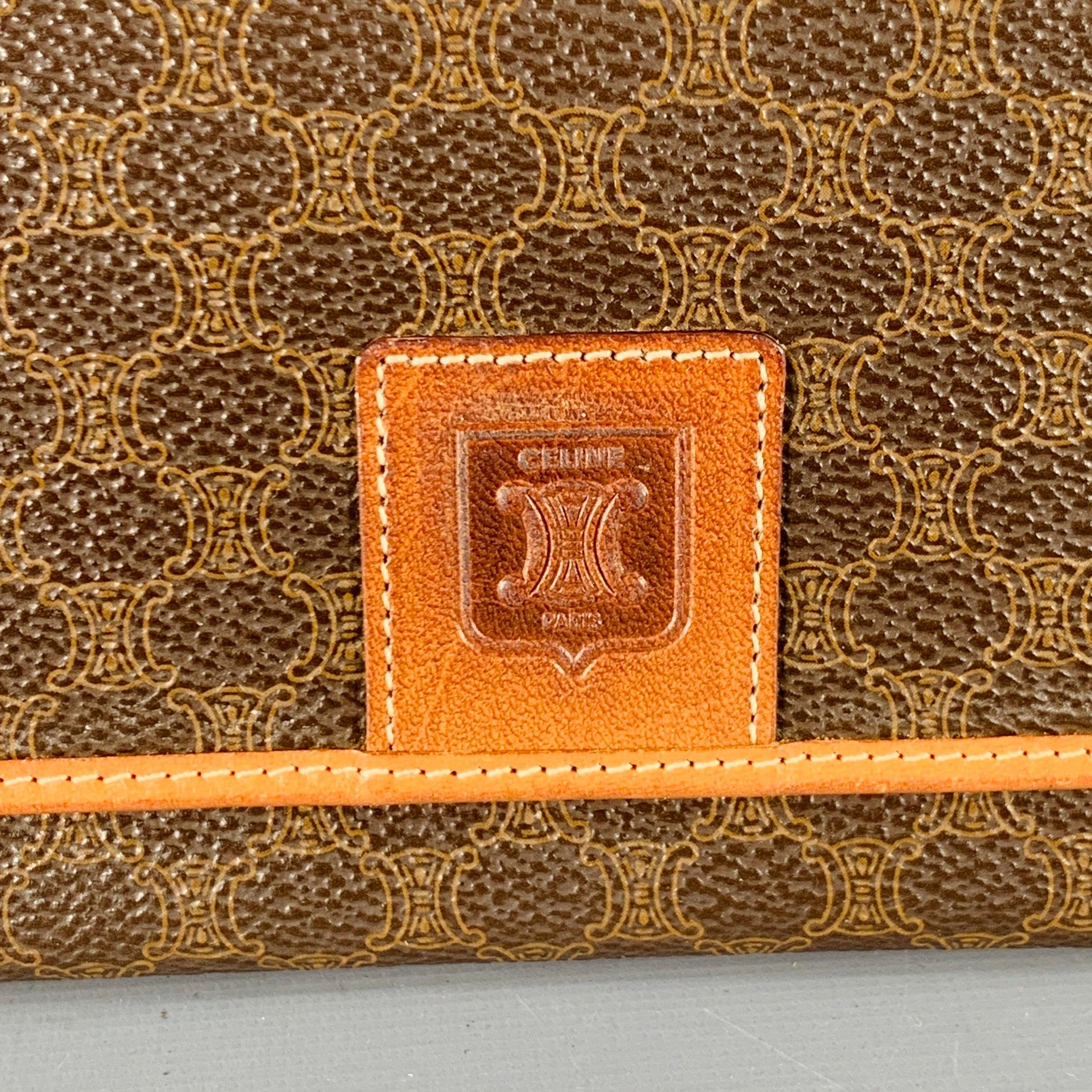 CELINE PARIS wallet
in a brown and tan coated canvas featuring a checkbook style, all over logo pattern, and single snap closure.Excellent Pre-Owned Condition.7.5 x 3.75 inches 
  
  
 
Sui Generis Reference: 138591
Category: Handbag & Leather