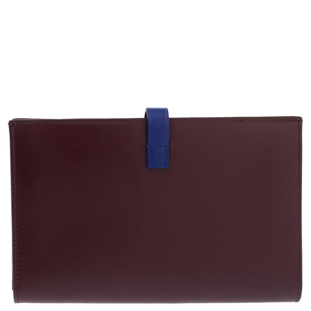 A beautiful wallet for stylish women, this Celine multifunction wallet is perfect to be carried solo while you step out to run errands. Crafted in leather, this wallet has shades of blue and burgundy, the brand detail on the front, and a simple