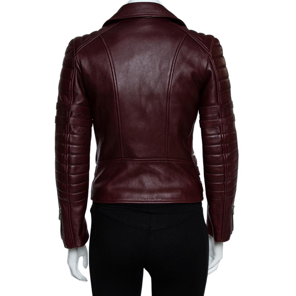 Biker jackets have become a fashion centerpiece and for those who want to try something exclusive, this Celine burgundy jacket is for them. It is made from leather with a front zipper closure, four zipped pockets, and buckled waist tabs. Pair up