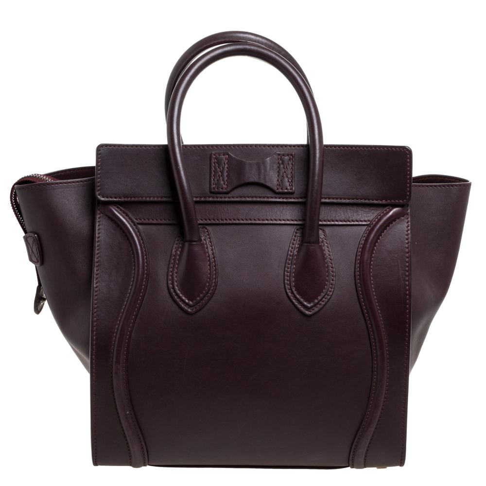 The mini Luggage tote from Celine is one of the most popular handbags in the world. This tote is crafted from leather and designed in a burgundy shade. It comes with rolled top handles and a front zip pocket. The bag is equipped with a well-sized