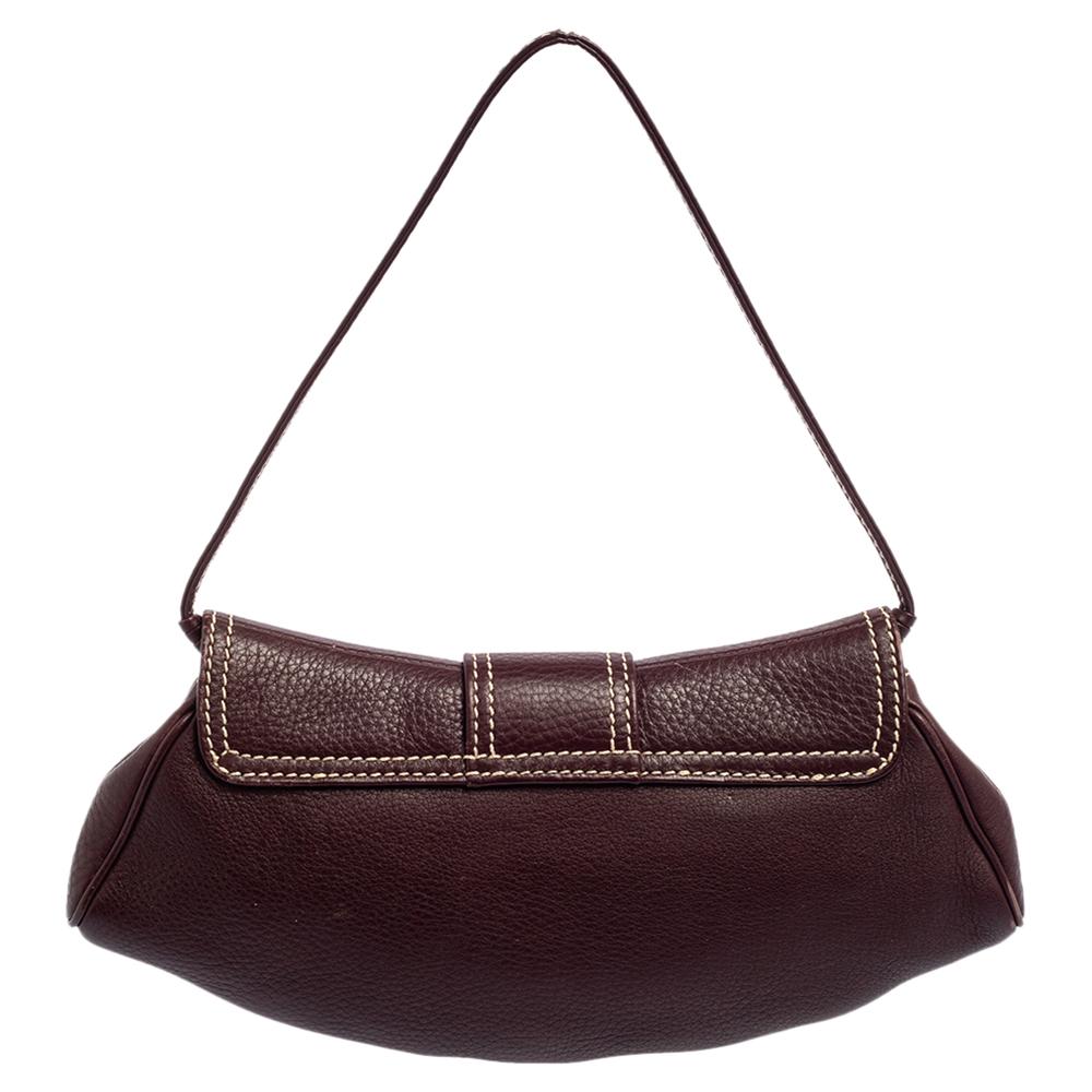 Celine brings us this well-shaped baguette bag that has been crafted from leather and flaunts a flap closure. The suede-lined interior is for your belongings and the bag is complete with a shoulder strap.