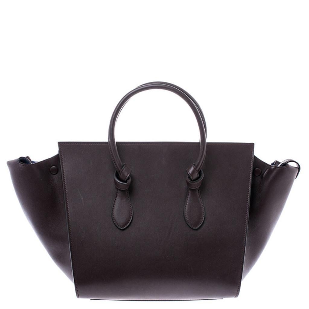 From its Tie collection, this Celine Tie tote is made from burgundy leather into a unique style that will definitely fetch you a lot of compliments. It features ‘knots’ at the base of each handle – a signature feature of this collection that gives