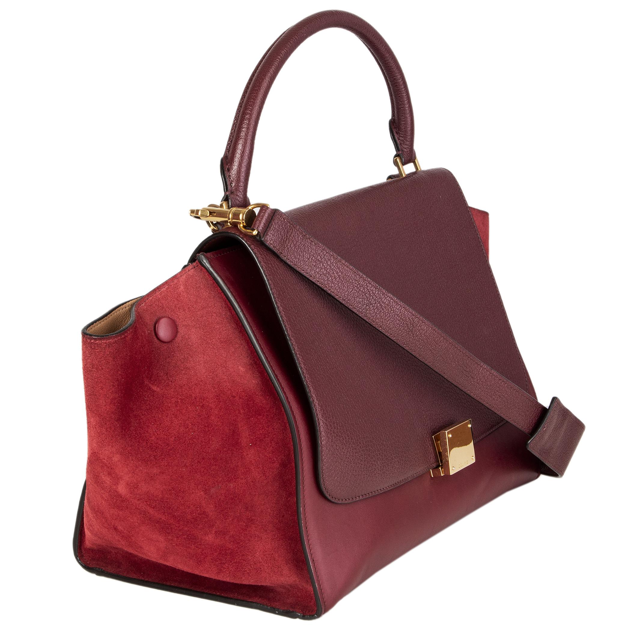 Celine 'Trapeze Small' shoulder bag in burgundy leather and suede with dark burgundy grained leather flap. Zipper pocket on the back. Detachbale shoulder strap. Clsoes with lock and zipper. Lined in beige leather with two open pockets against the