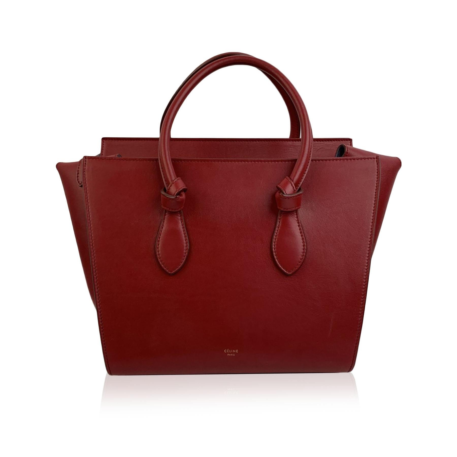 This beautiful Bag will come with a Certificate of Authenticity provided by Entrupy, leading International Fashion Authenticators. The certificate will be provided at no further cost.

Celine Tie Knot Bag in burgundy leather. The bag features a