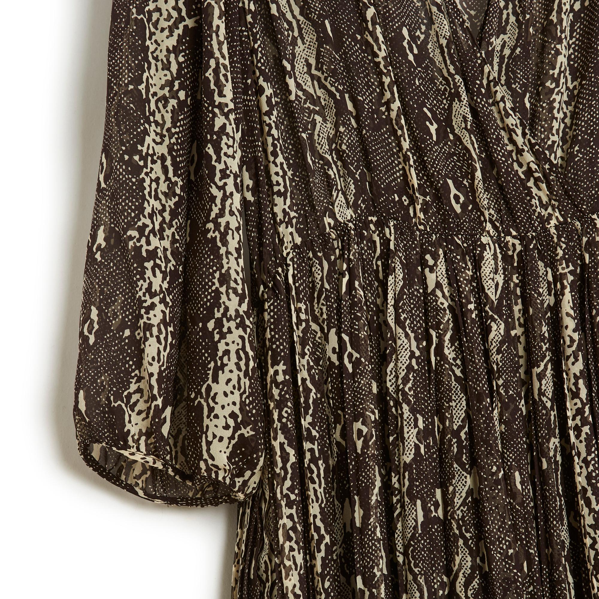 Celine dress AW2019 collection by Hedi Slimane in python print silk crepe, deep V-neckline crossed at the front, gathered waist, long sleeves slightly gathered at the bottom, unlined, fastening with a long zip on the side. Size 42FR but the dress