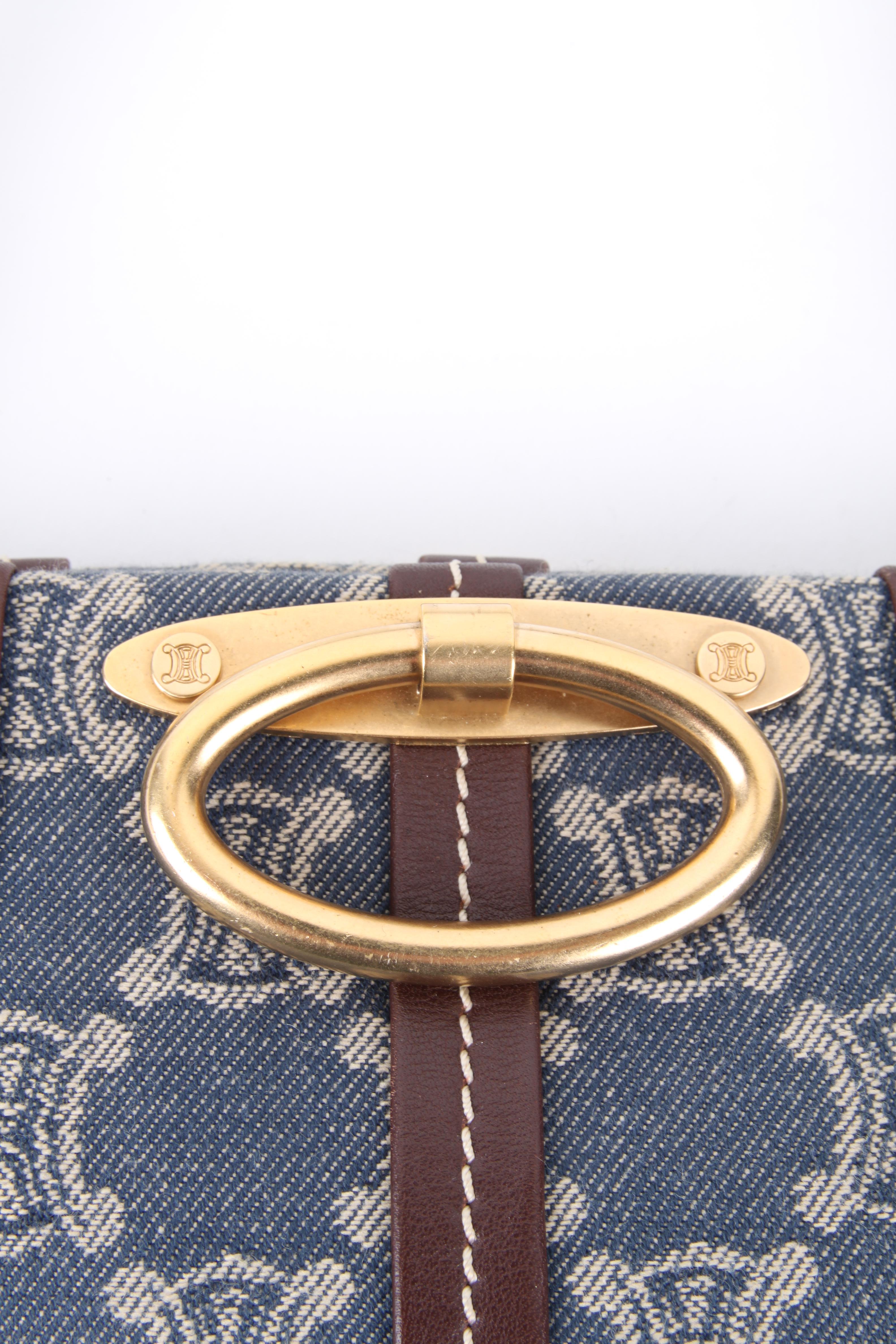 Céline by Michael Kors Blue Cotton Brown Leather Monogram Logo Shoulder Bag.

This little bag makes a big statement. It features a cotton exterior with matching blue canvas lining. The bag features a blue canvas lining, snap closure, one main