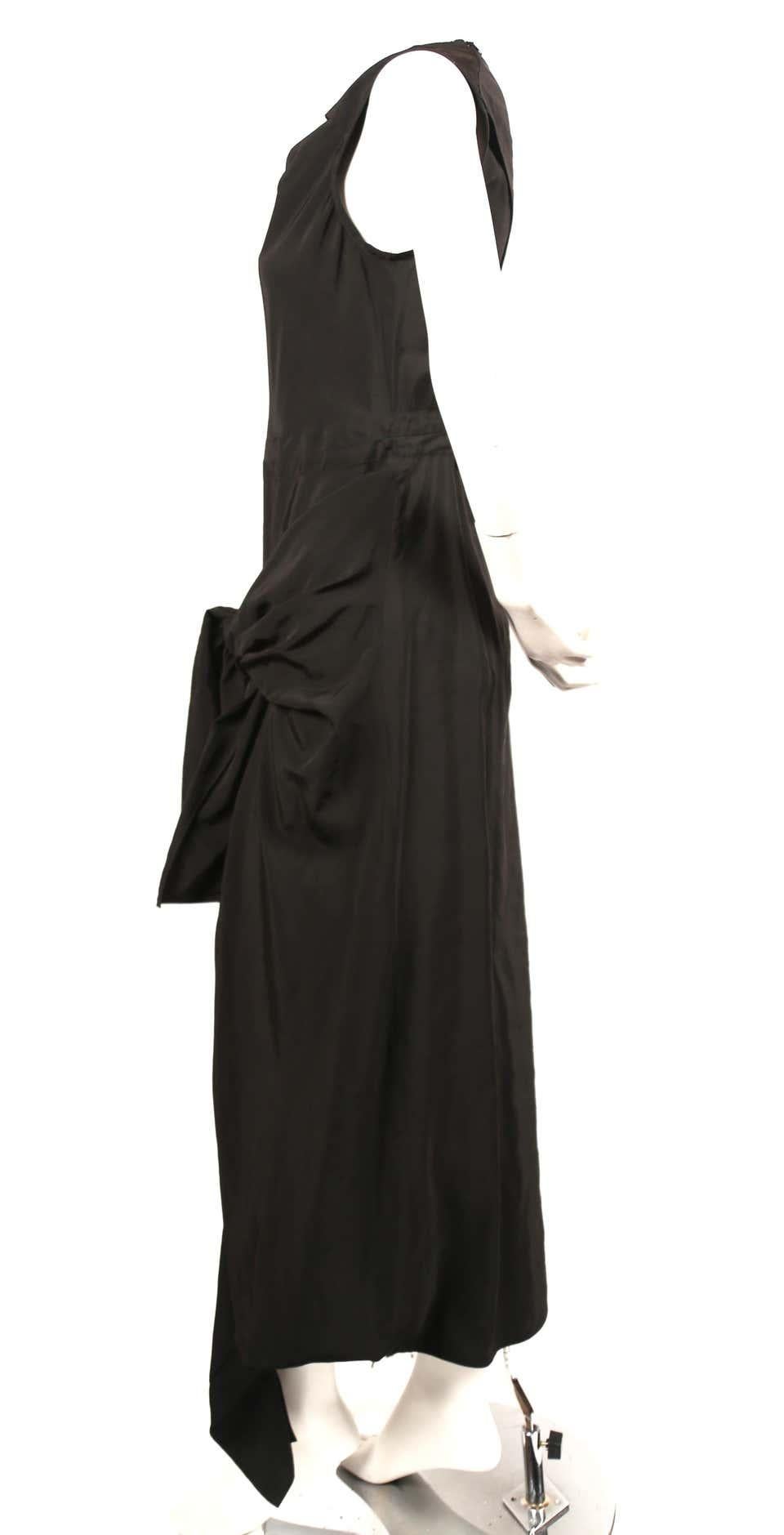 Jet-black dress with twisted neckline, ties at hips and cut out at back designed by Phoebe Philo for Celine dating to resort of 2016. Best fits a French size 40. Approximate measurements: shoulder 15