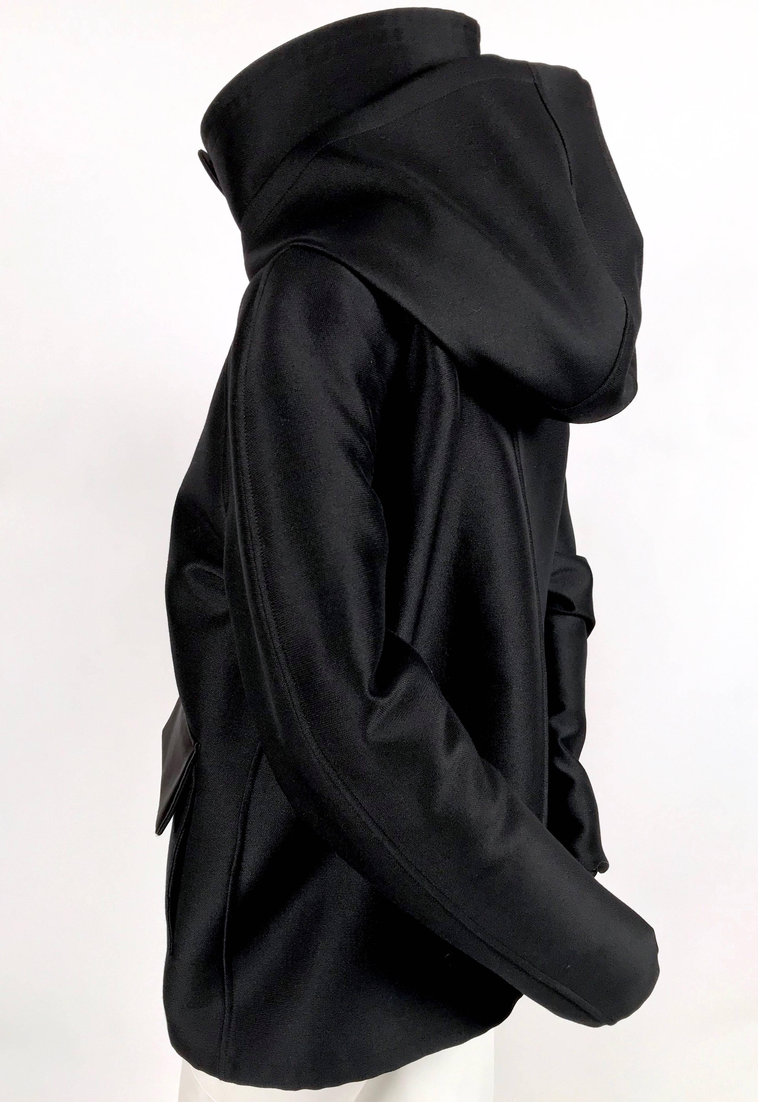 Jet black jacket with hood and satin accents designed by Phoebe Philo for Celine as seen in the pre-fall collection of 2015. French size 38. Approximate measurements: bust 42
