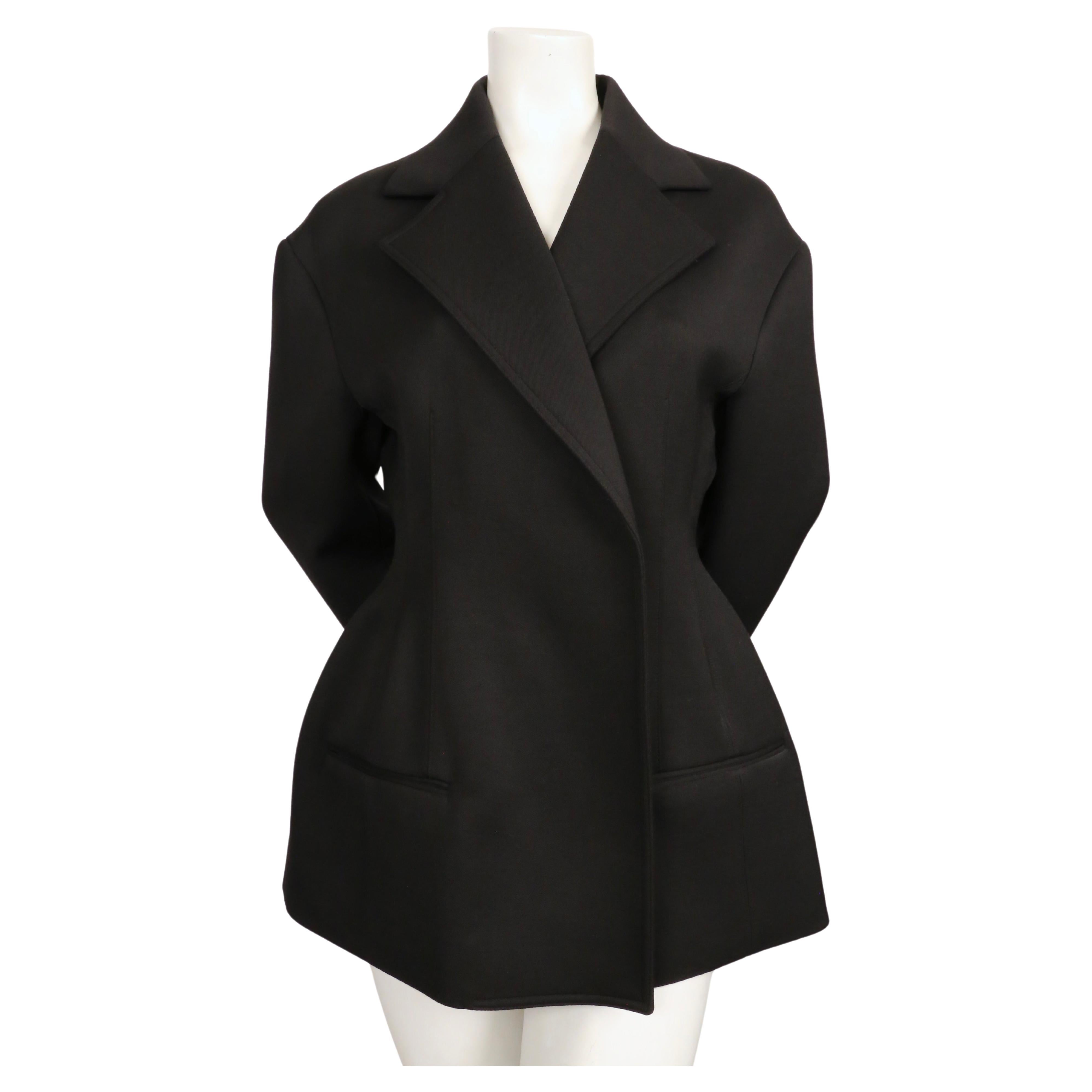 Black hourglass shaped jacket with open closure designed by Phoebe Philo for Celine dating to resort of 2016 as featured in the Resort ad campaign. No size indicated however this is probably a French 38 or possibly a 40. Approximate measurements
