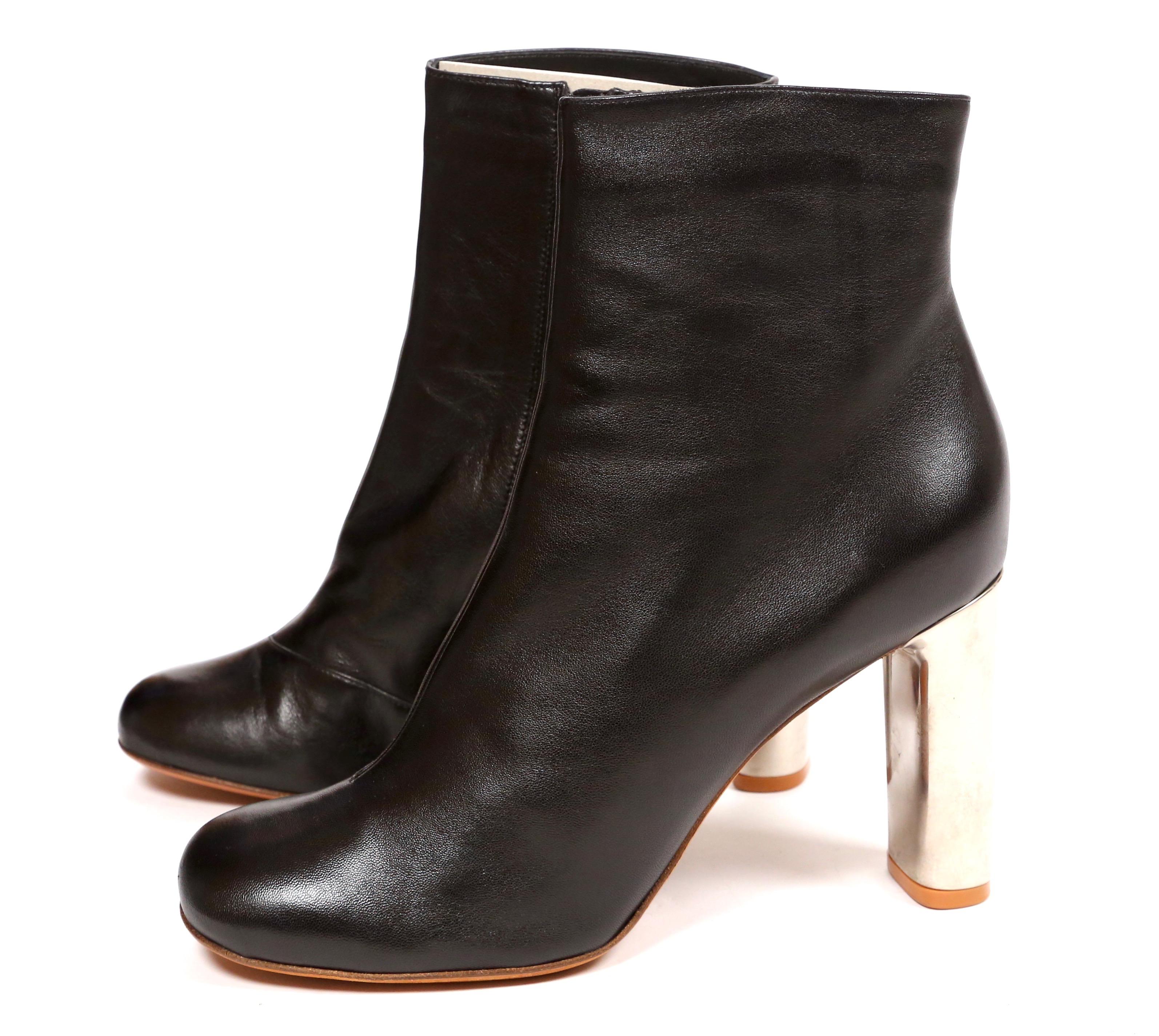 Jet-black, lambskin leather, ankle boots with silver heels designed by Phoebe Philo for Celine. French size 41. Approximate measurements of insoles: length 10.5