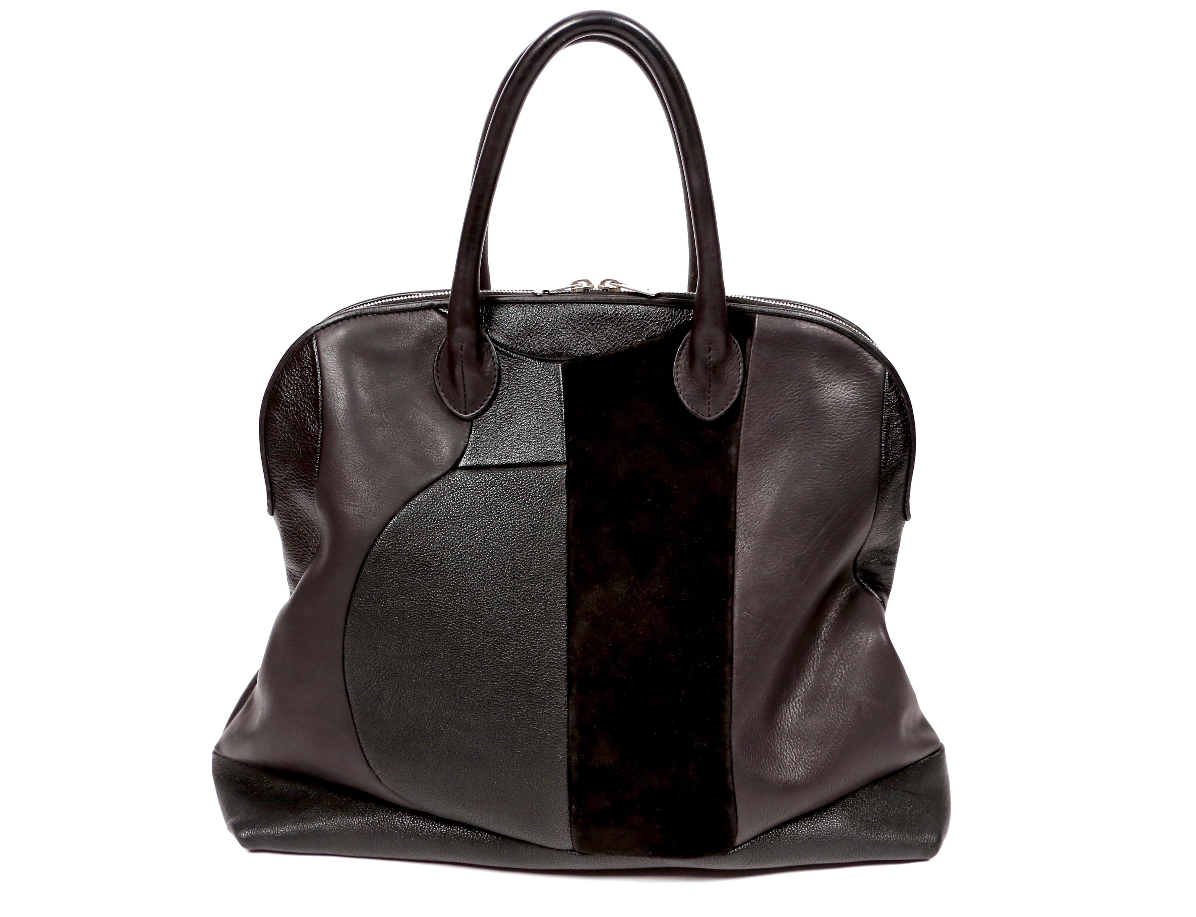 Black bowling style bag featuring different types of leather and suede in a patchwork motif designed by Phoebe Philo for Celine circa 2010. Approximate measurements: 17.5