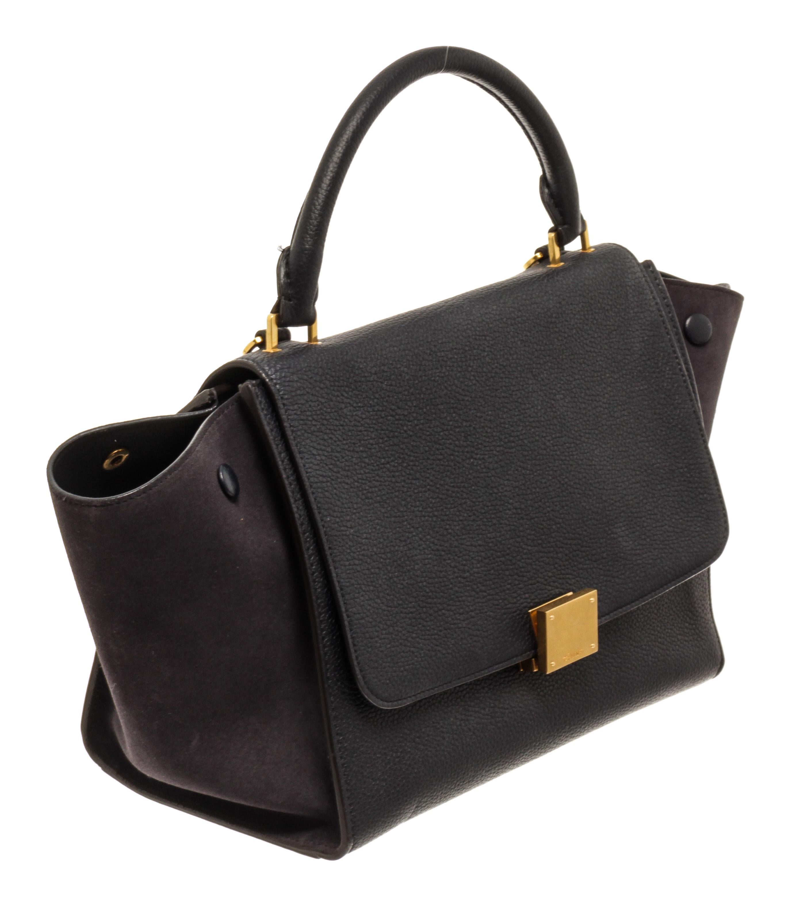 Celine by Phoebe Philo Black Leather Trapeze Bag with soft smooth leather, single rounded top handle, adjustable detachable shoulder strap, foldover top, flip-lock fastening.

80426MSC