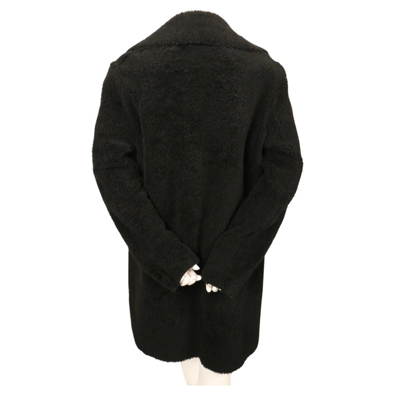 Jet-black shearling coat with open closure designed by Phoebe Philo for Celine. French size 40. Approximate measurements: shoulder 18
