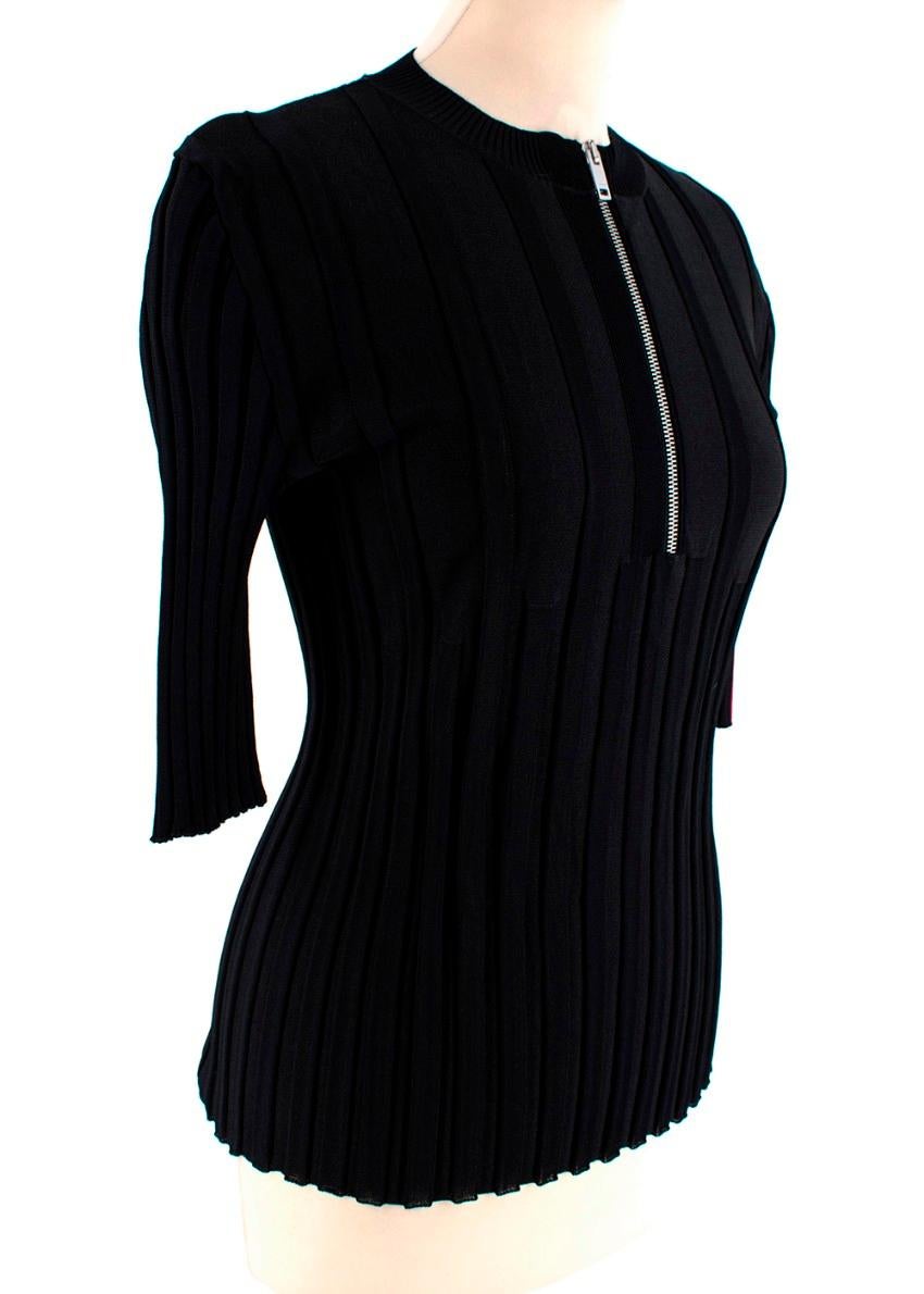 Celine Black Stretch Jersey Ribbed Zip-Up Top

- Black Stretch Jersey 
- Ribbed design 
- Silver metal zip-front
- 1/2 sleeves
- White and red stripe on left sleeve

Materials:
Main - 69% Viscose, 29% Silk, 1% Polyamide, 1% Elastane
Lining - 100%