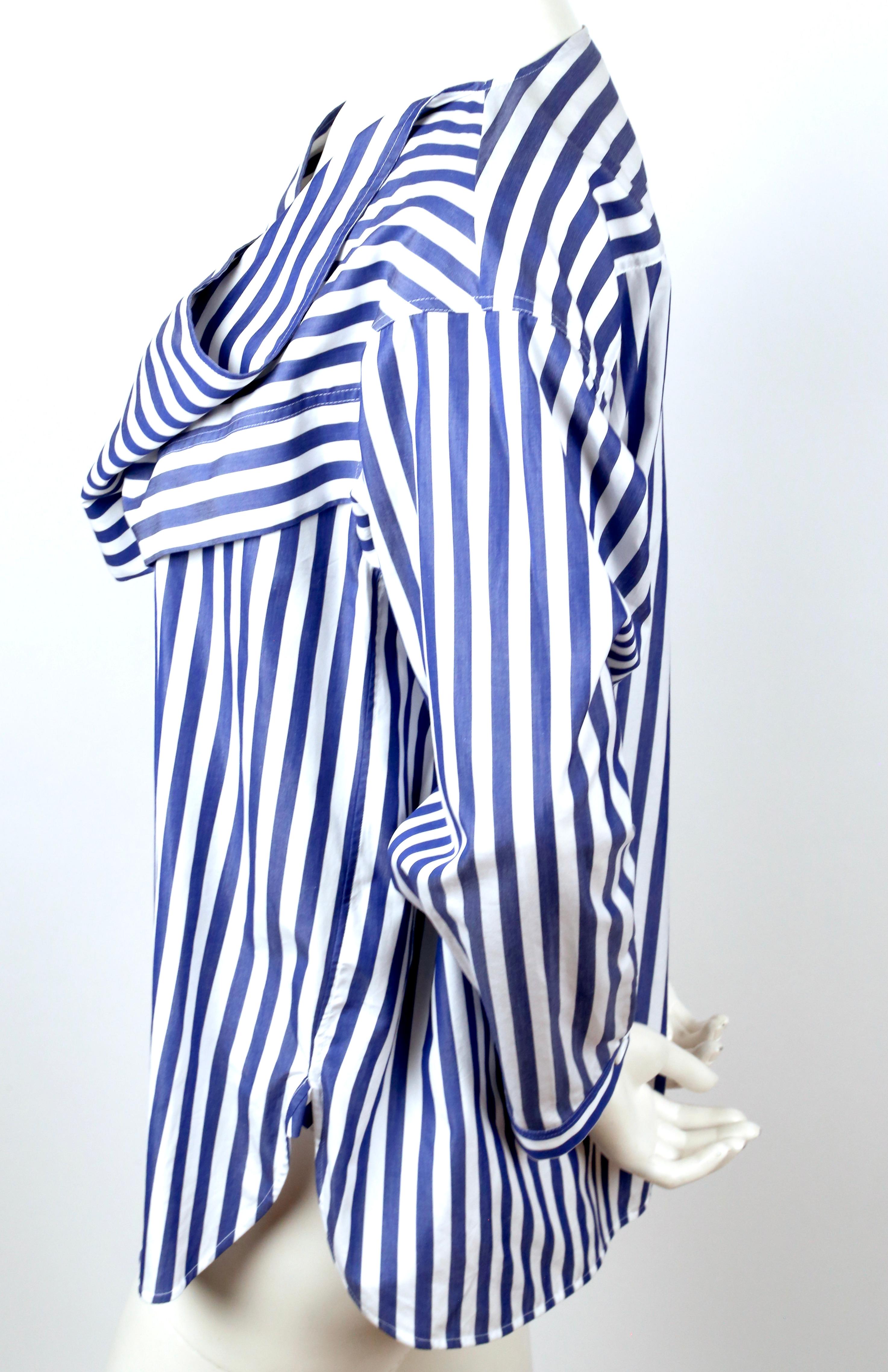 Draped, cotton poplin blouse with blue stripes designed by Phoebe Philo as seen for resort 2016. This piece features a drape at the chest, long sleeves and a relaxed fit.  French size 38. Fabric content: 100% cotton. Made in Madagascar. Excellent