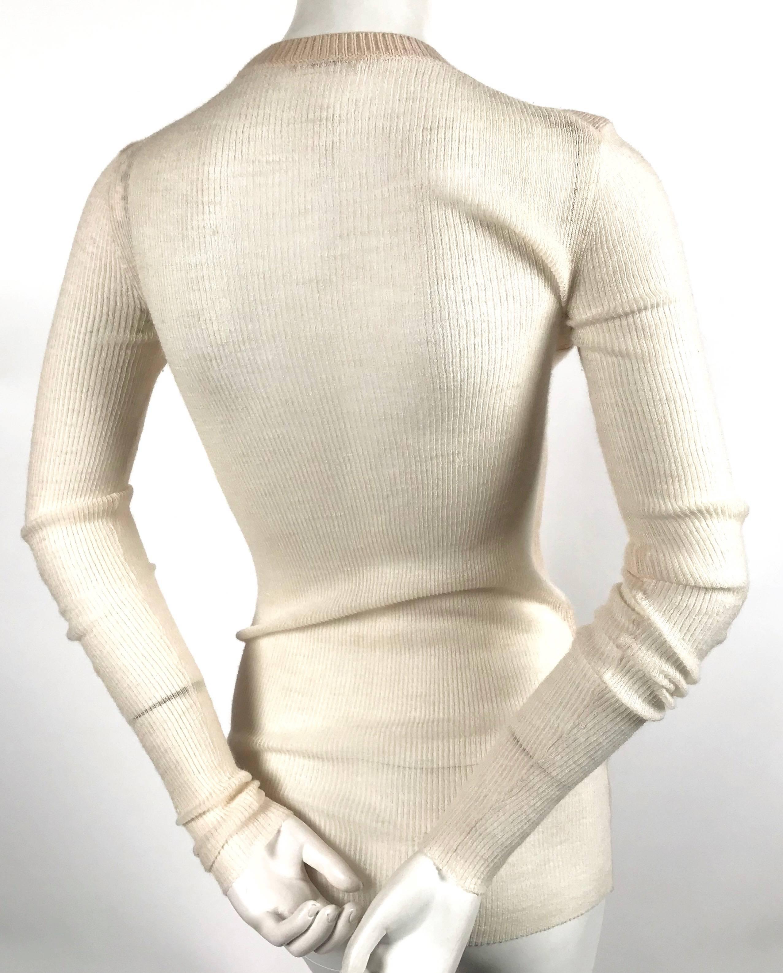 Cream cashmere and alpaca sweater with sheer sleeves and back designed by Phoebe Philo for Celine. XS. Approximate measurements (unstretched): shoulder 14