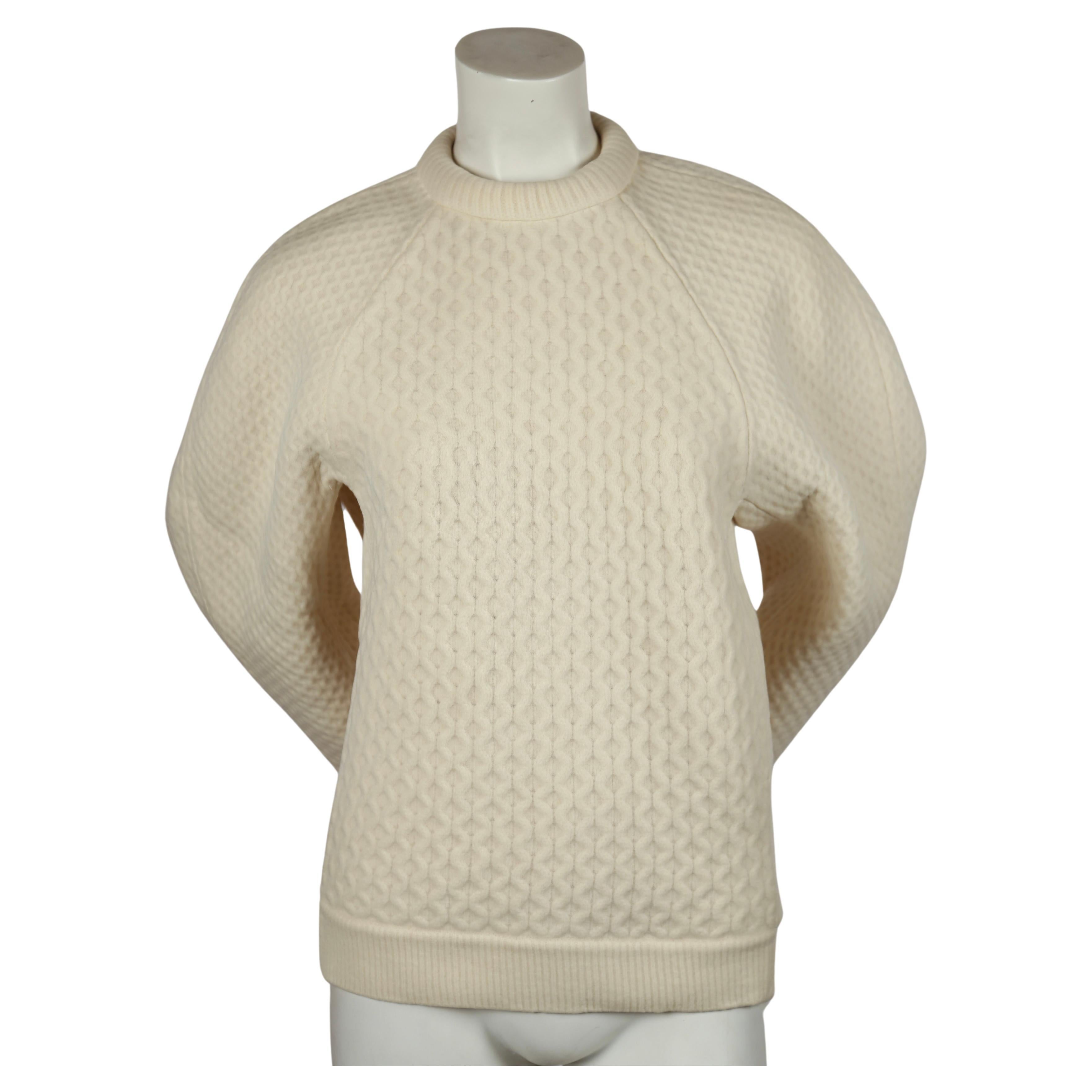 Spectacular oversized cream sweater with rounded sleeves and net overlay designed by Phoebe Philo for Celine. This is a very rare piece of Old Celine. Labeled a Size S.  Fabric content: 71% Laine and 18% cashmere, 9% cotton and 2% polyamide . Zips