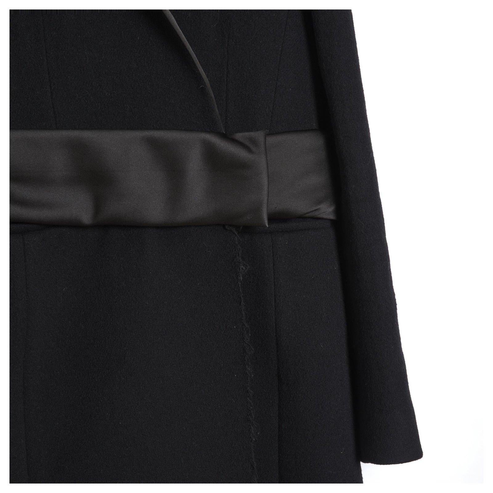 Céline coat from the Pre Fall 2014 collection by Phoebe Philo in a tuxedo-style wool blend with a small notched collar dressed in satin, a wide satin padded belt at the waist (high), raw frayed edges on the bottom front, 2 horizontal slit pockets