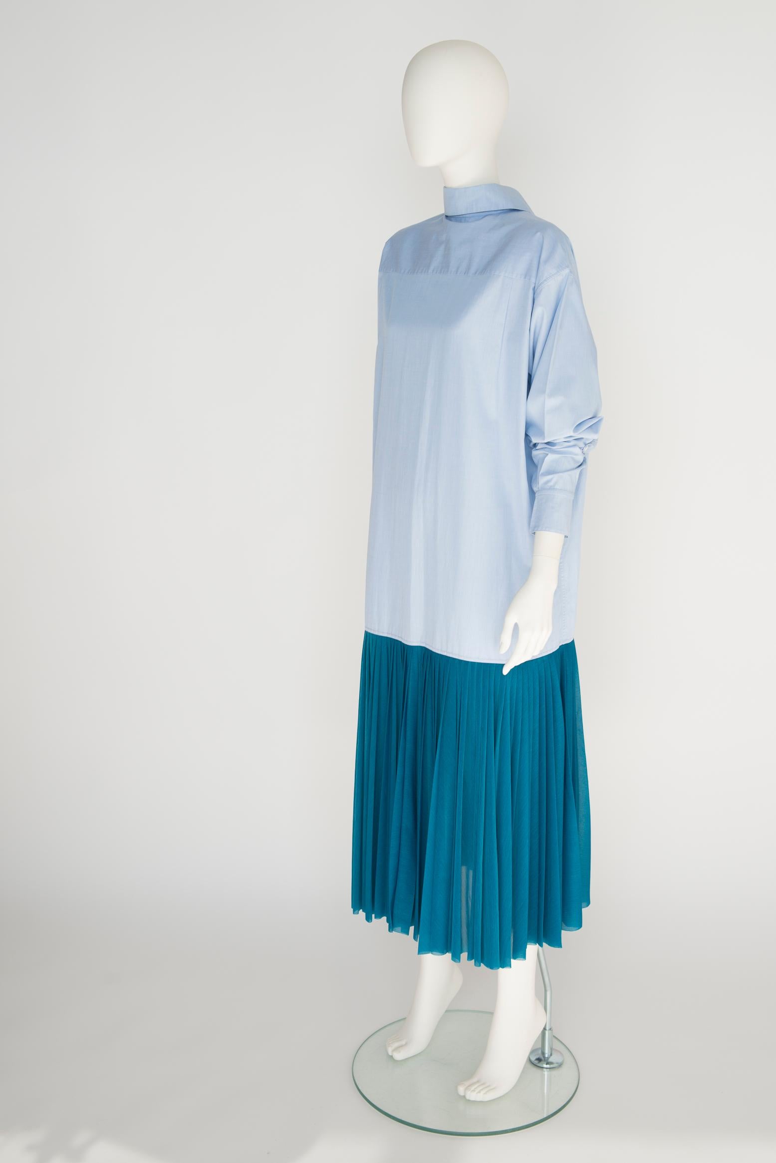 As seen on the Spring 2017 runway show (look 36), this Céline by Phoebe Philo shirt dress is mainly made from 100% cotton Chambray in a sky-blue hue, while the semi sheer pleated bottom is a 100% polyester bright teal blue. Designed for a loose fit,